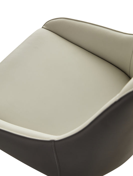 Closeup of a modern taupe and ivory leather armchair seat with visible stitching