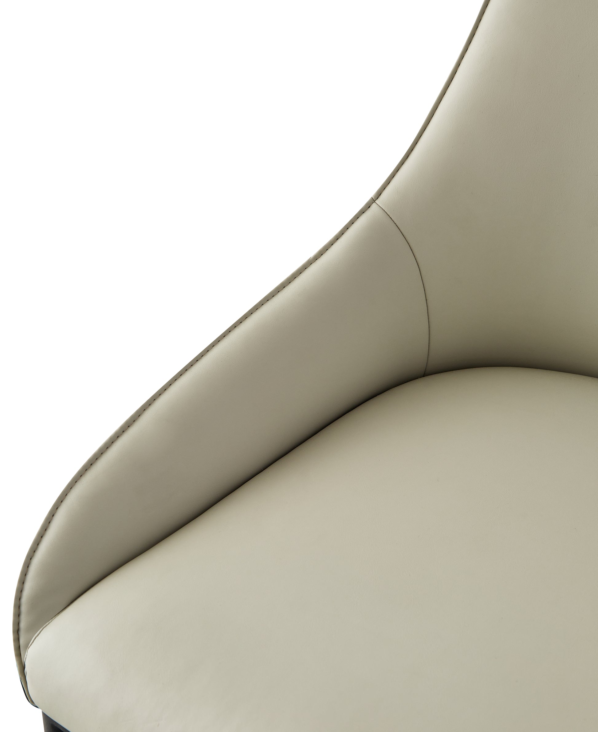 Closeup of a light beige leather accent chair with detailed stitching