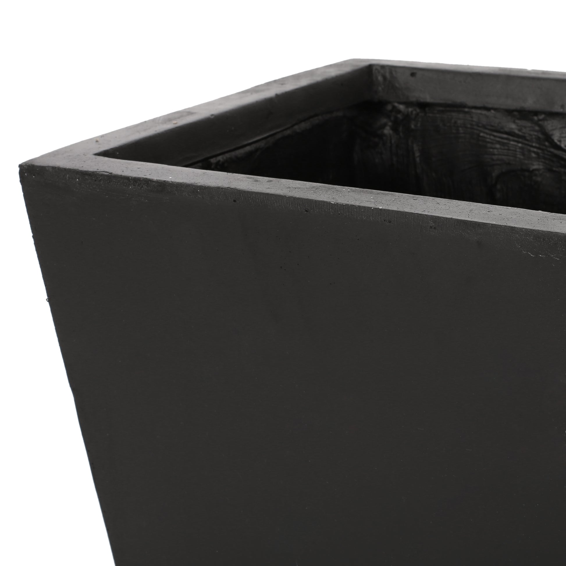 Closeup of a tall dark grey rectangular concrete planter highlighting its textured interior