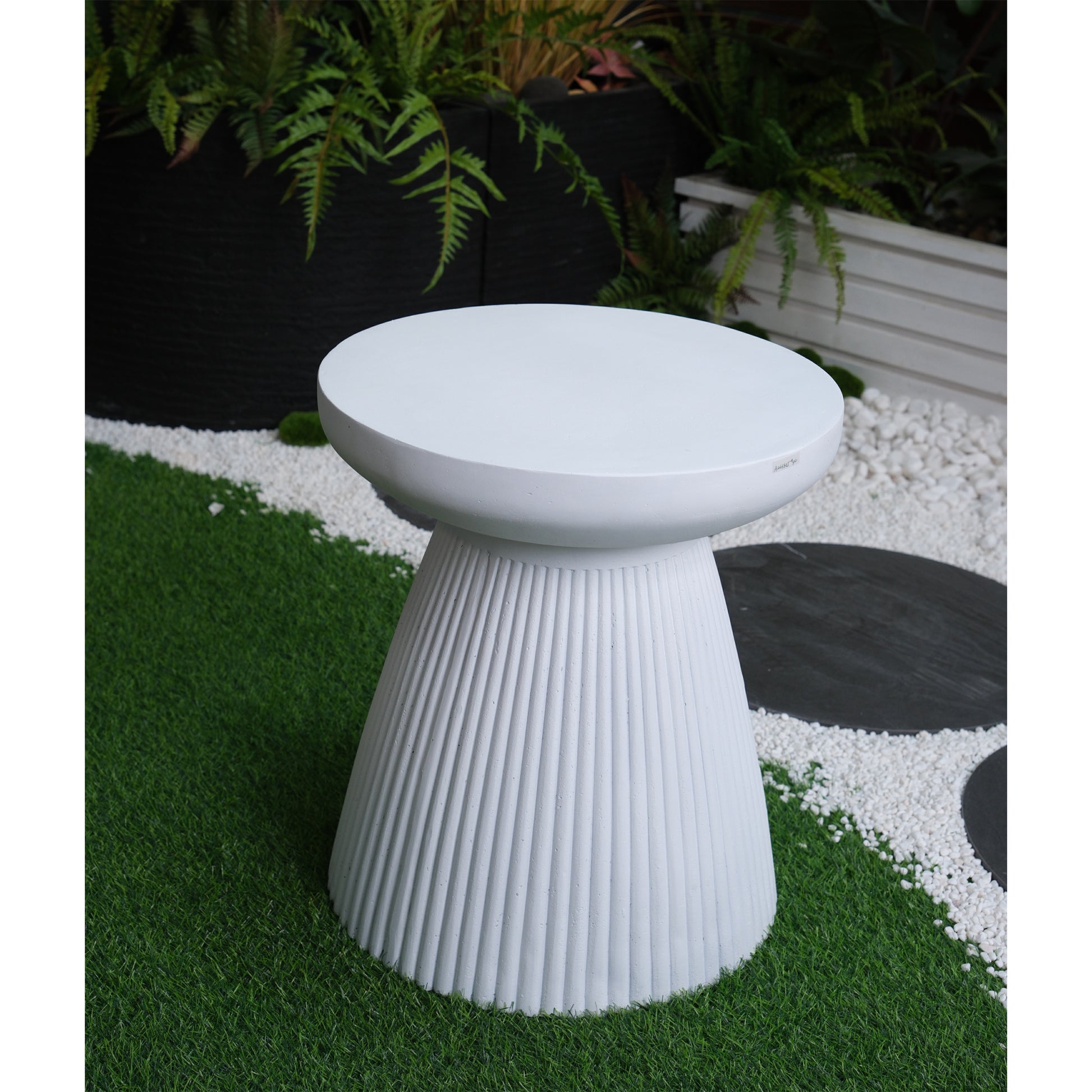 Modern white fluted outdoor side table on artificial grass