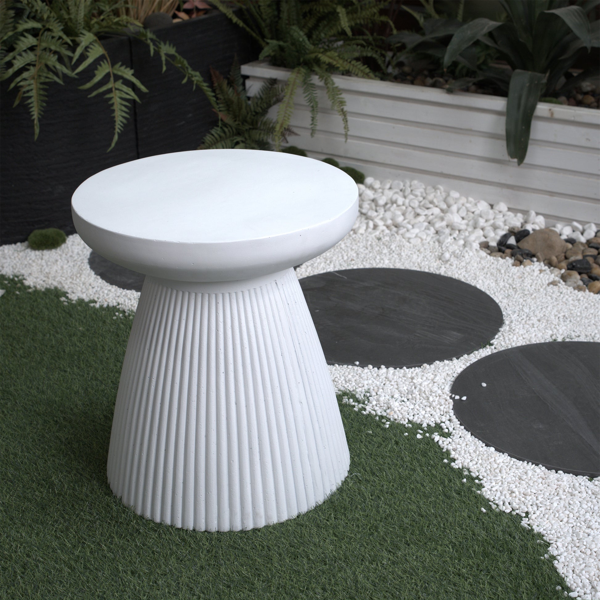 White fluted garden stool with a round flat top perfect for outdoor use