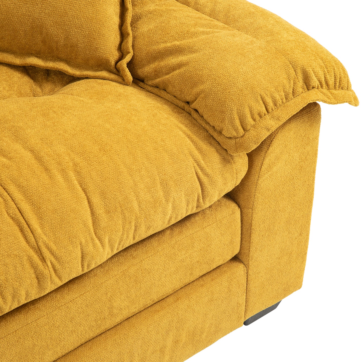 Plush mustard yellow textured fabric sofa armrest detail with plump cushions