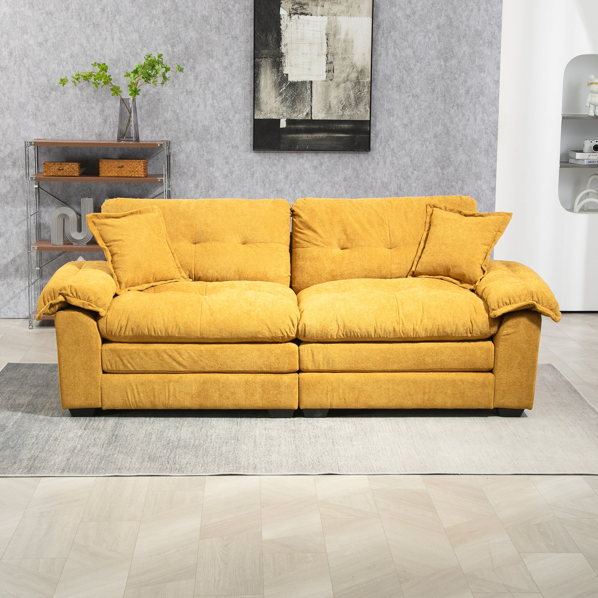 Mustard yellow fabric sofa with plush cushions and two throw pillows