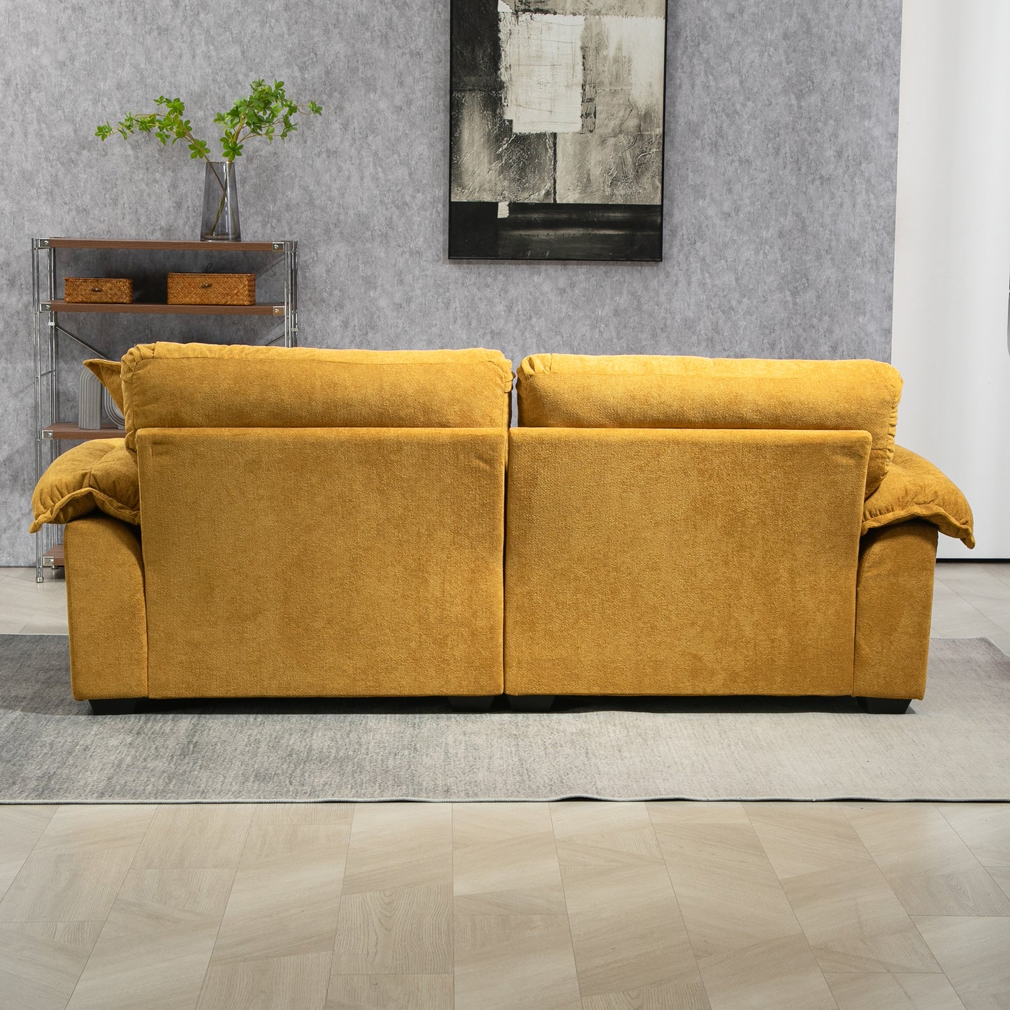 Back view of a plush mustard yellow sofa with deep seating and tufted back cushions