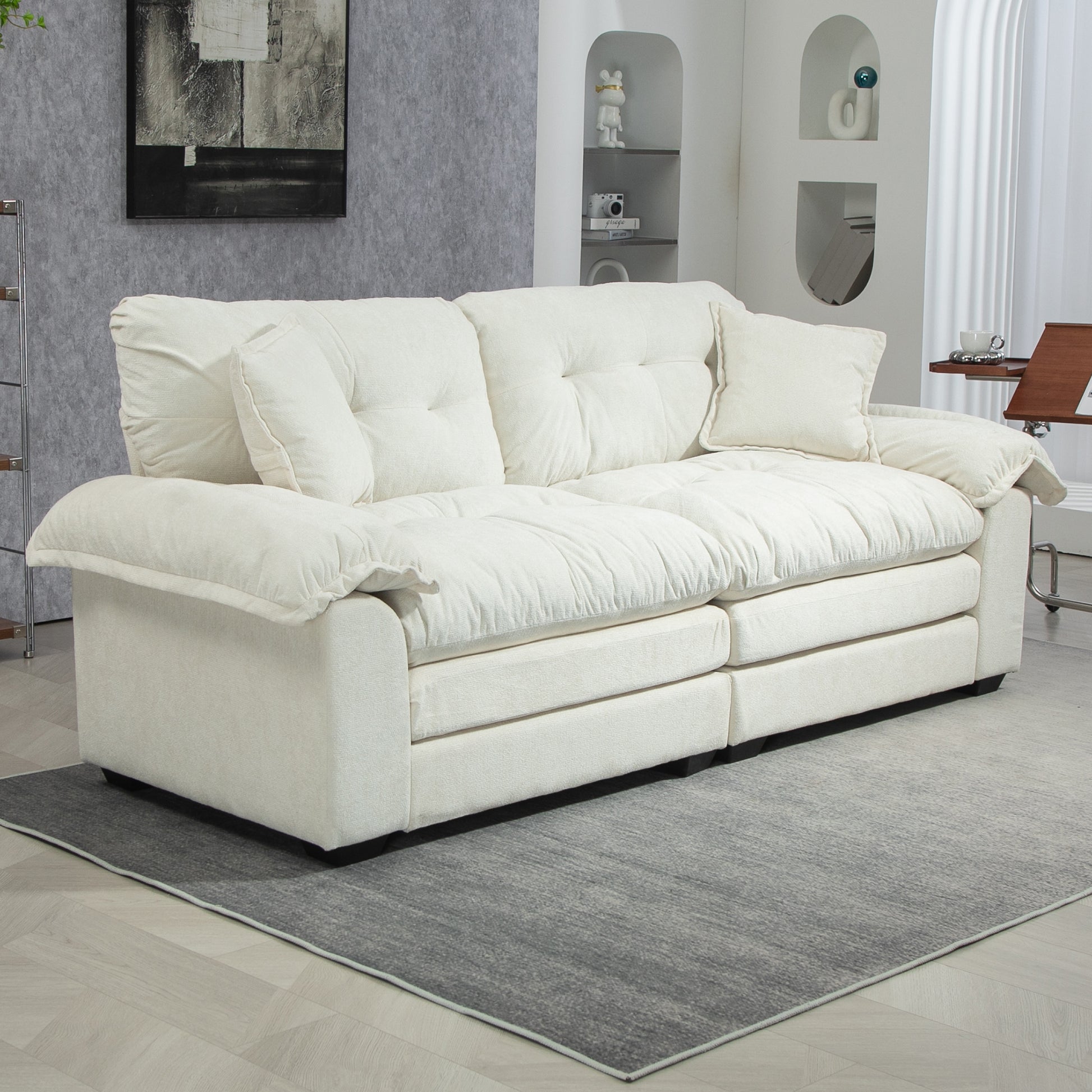Plush cream white fabric sofa with deep tufted cushions and extra throw pillows perfect for living rooms