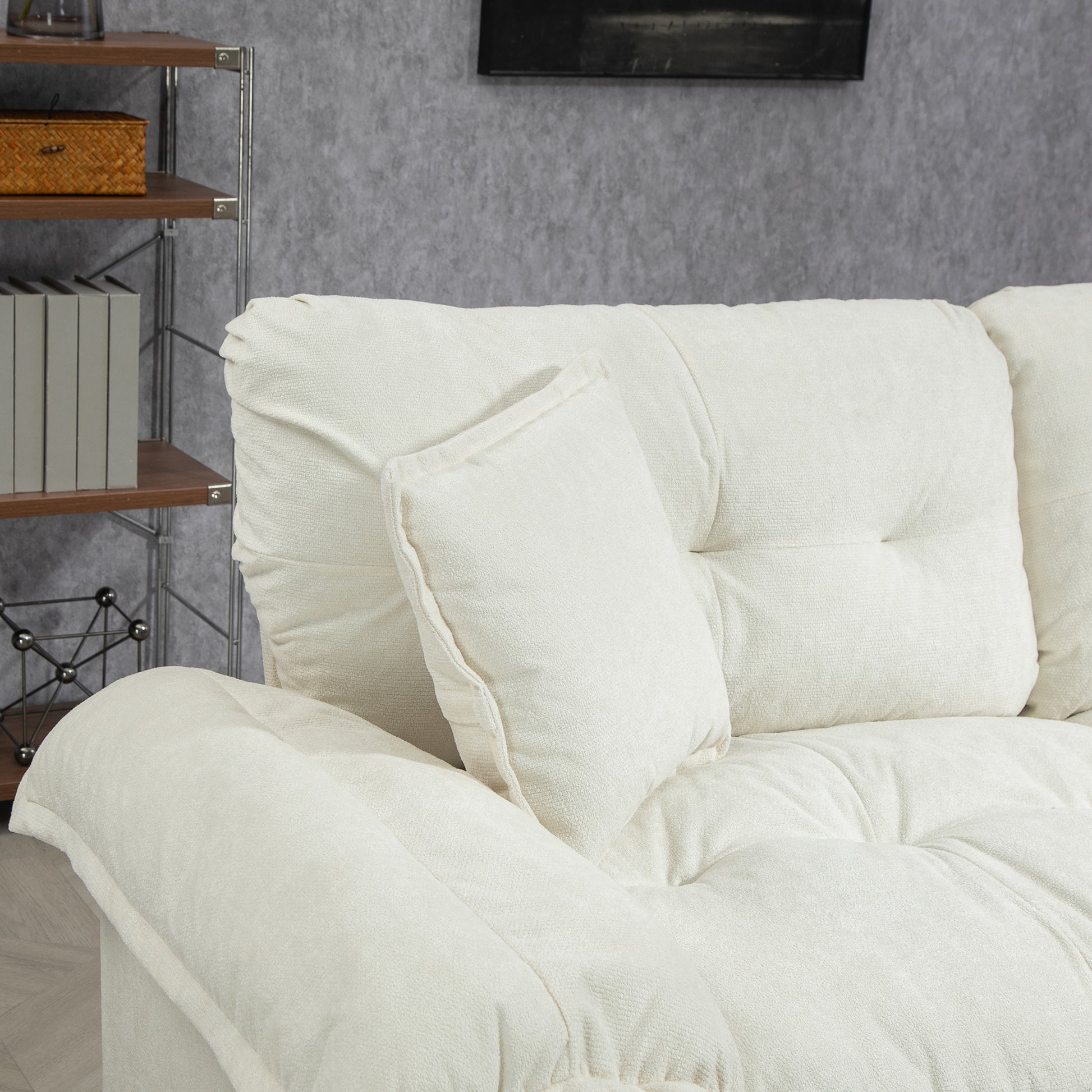 Cozy cream textured fabric sofa with plush cushions and a matching throw pillow