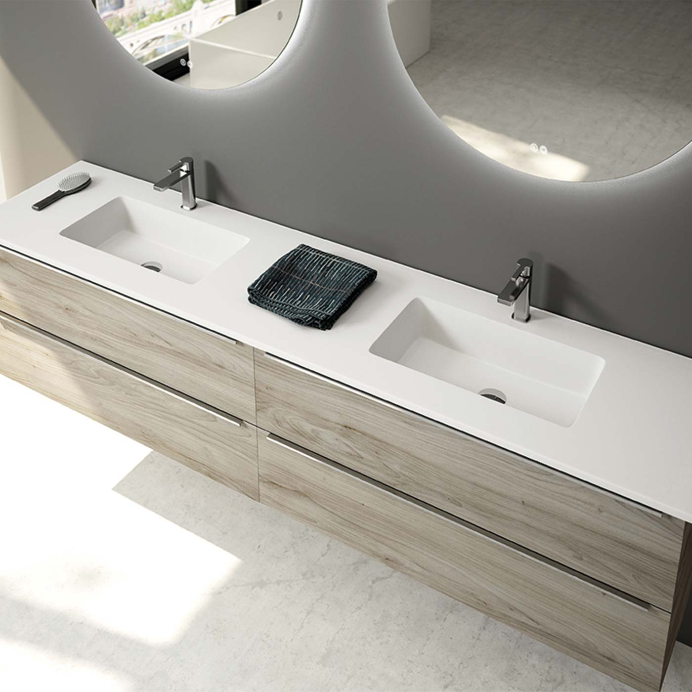 Modern double vanity with integrated white sinks and light wood cabinetry