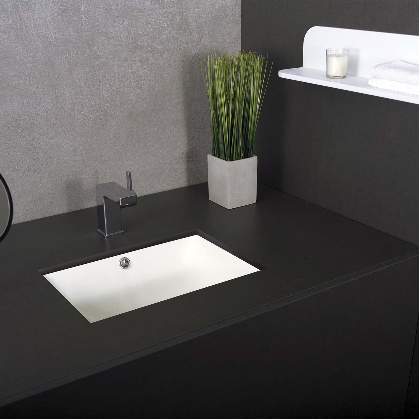 Modern integrated white ceramic bathroom sink with chrome faucet on dark vanity