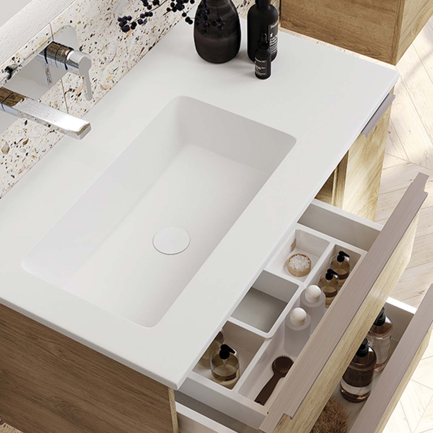 Modern white integrated sink with polished chrome faucet on a white vanity top
