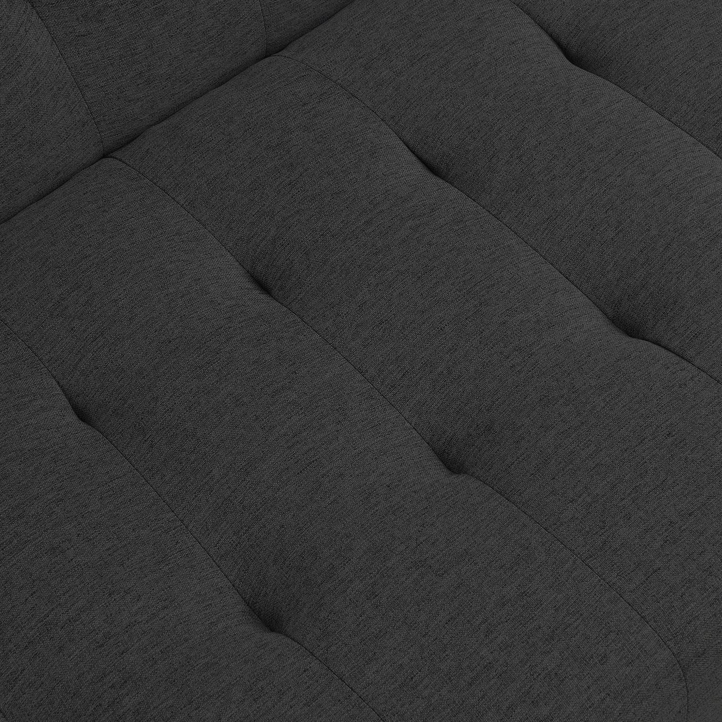 Dark gray tufted fabric closeup showing textured weave and stitching