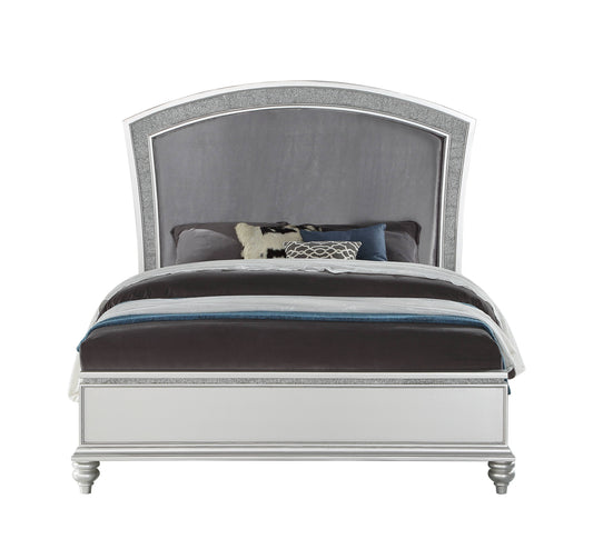 Silver upholstered queen bed with crystalinlaid arched headboard and dark bedding