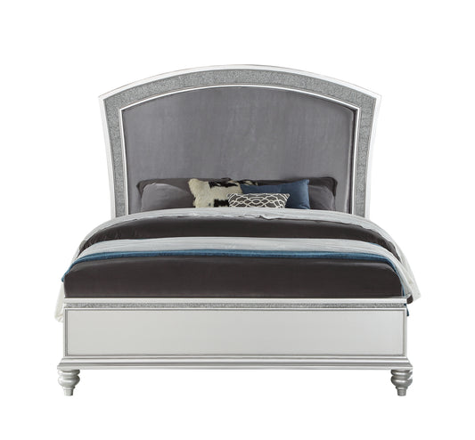 Glamorous king bed with a silver crystalencrusted arched headboard and plush velvet upholstery featuring decorative pillows