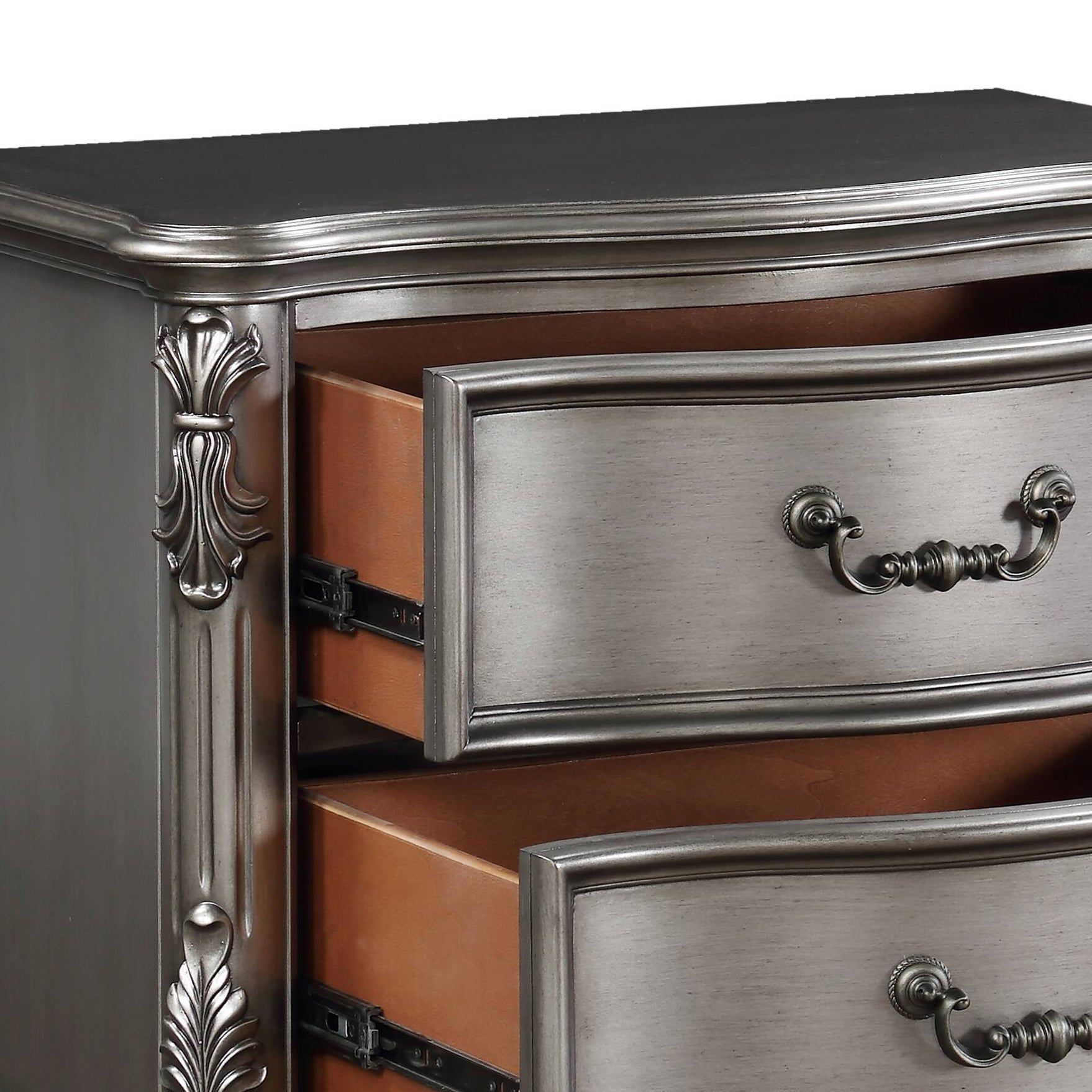 Antique silver dresser with ornate handles and carved details on drawers