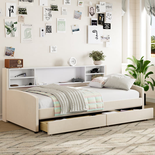 Cream upholstered daybed with pullout drawers and a white bookshelf headboard