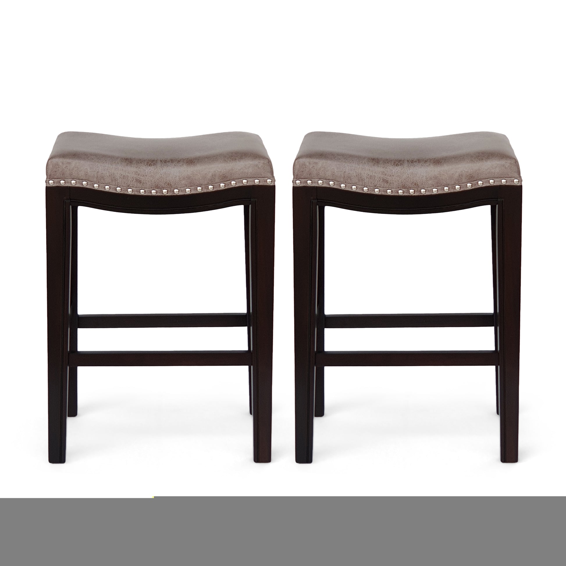 Two brown leather counter stools with silver nailhead trim and dark wood legs