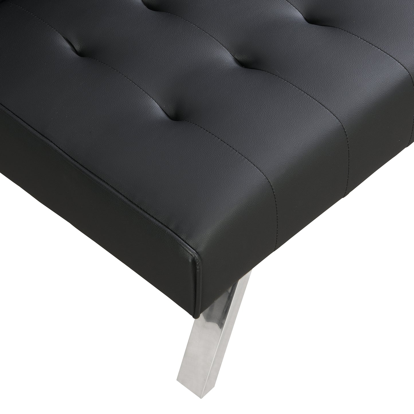 Closeup of tufted black faux leather sofa seat with silver metal leg detail