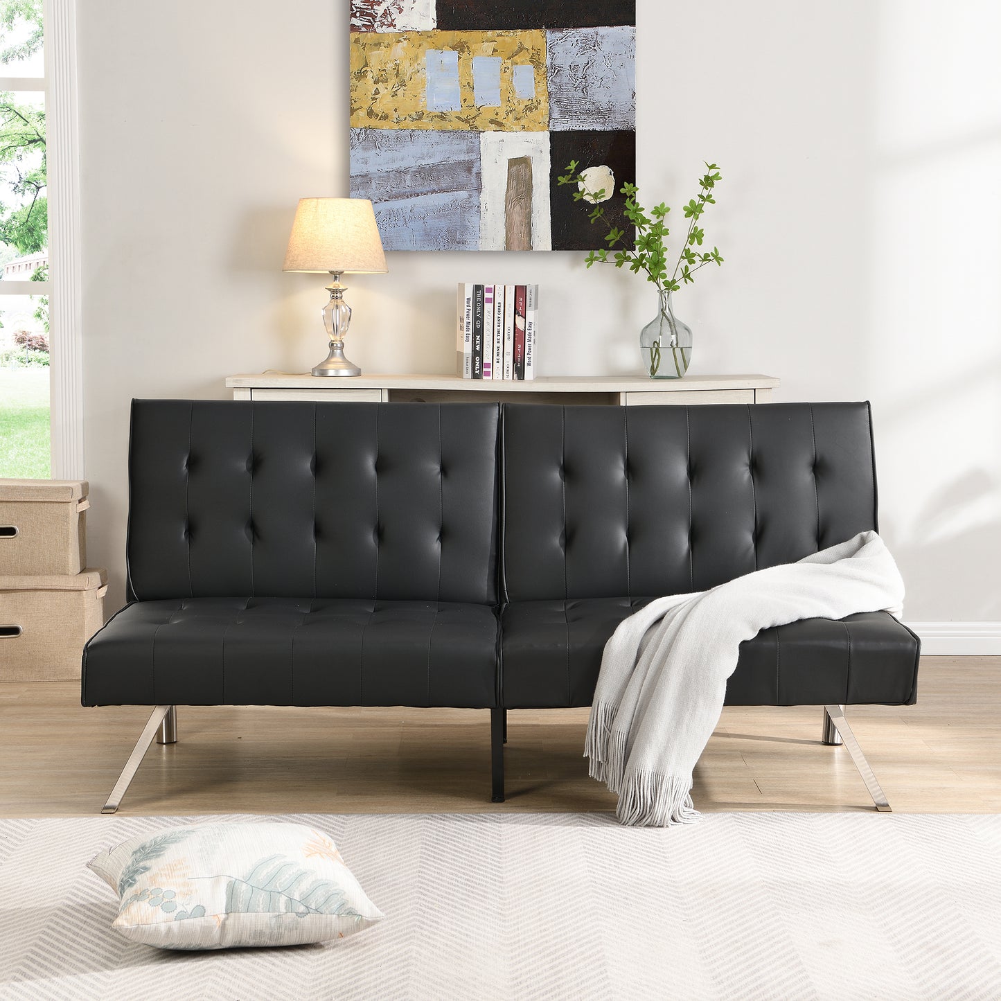 Black tufted vegan leather futon sofa with modern chrome legs perfect for small spaces