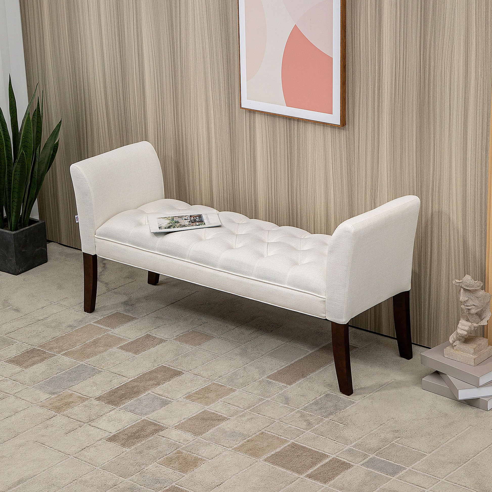 White upholstered bench with tufted seat and dark wood legs