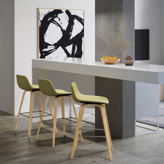 Lime green upholstered bar stool with light wood legs and chrome footrest