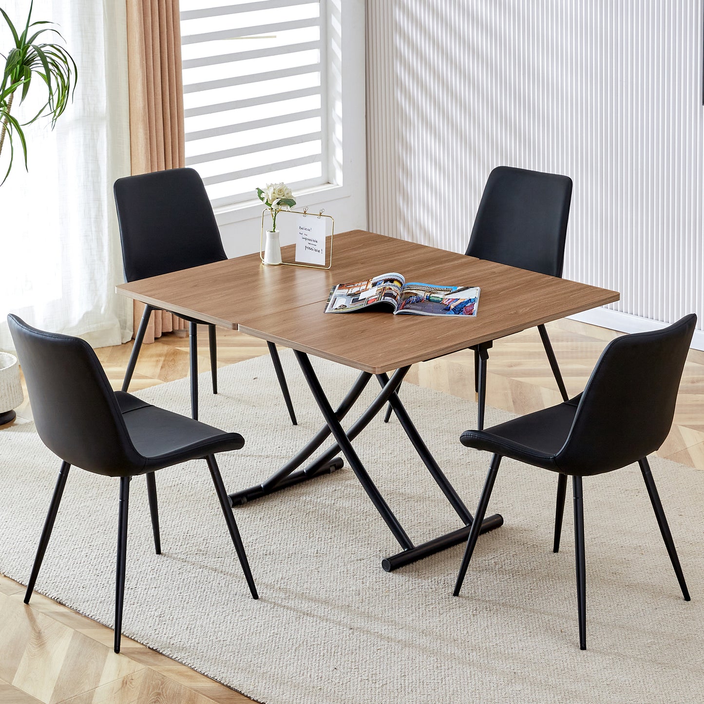 Modern wooden dining table with four black chairs ideal for small spaces