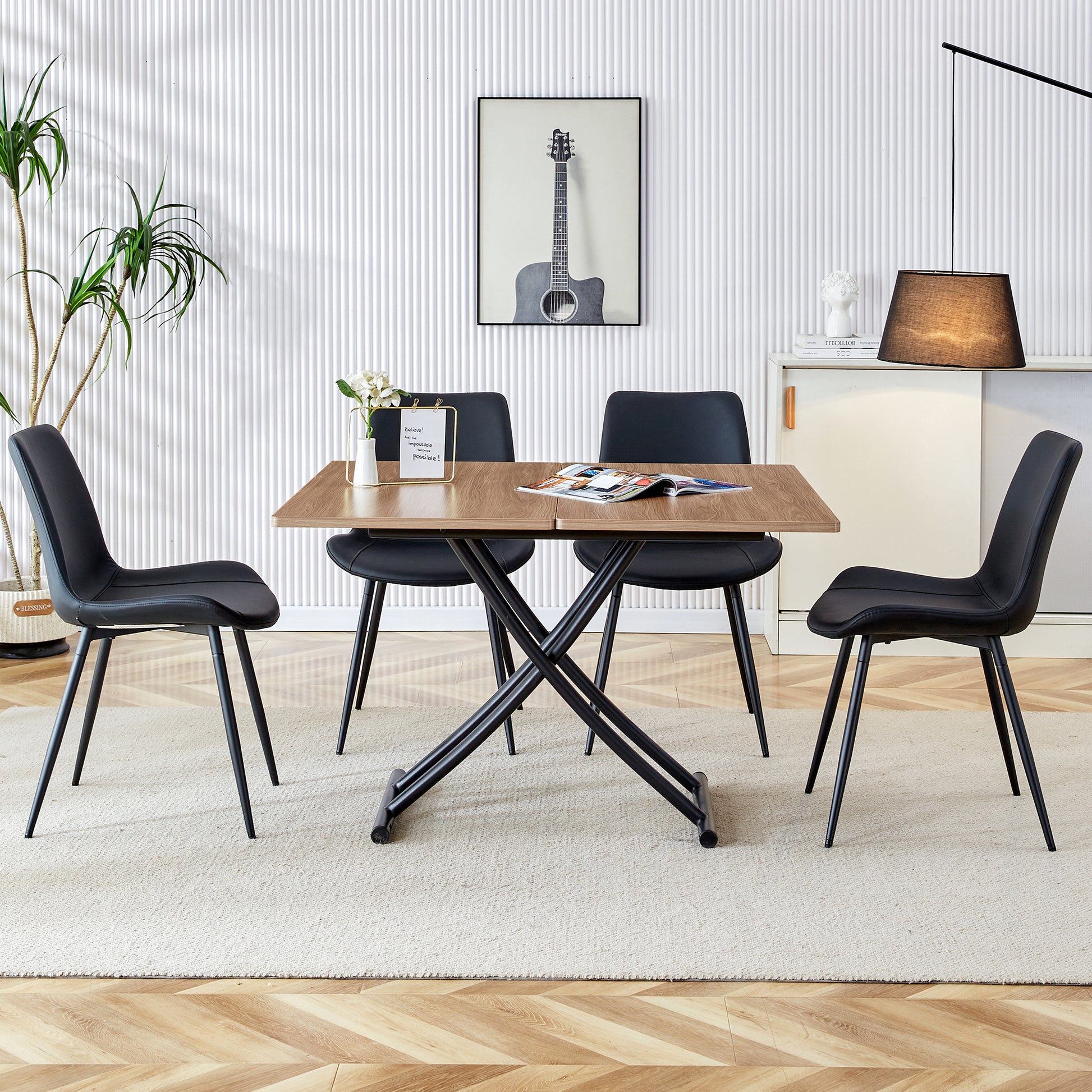 Wooden lift top dining table with black metal base and four black faux leather chairs