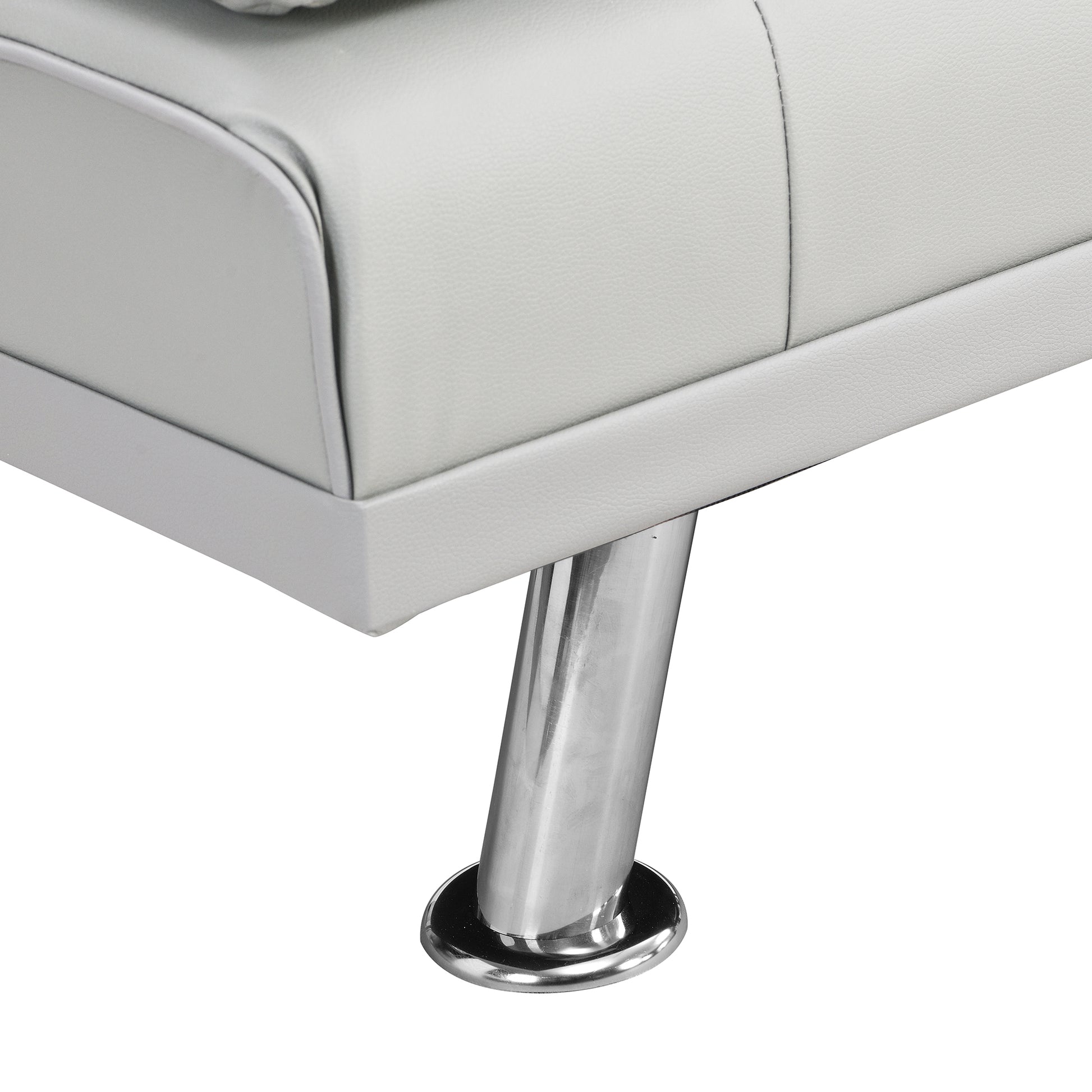 Closeup of white faux leather couch corner with sleek chrome leg