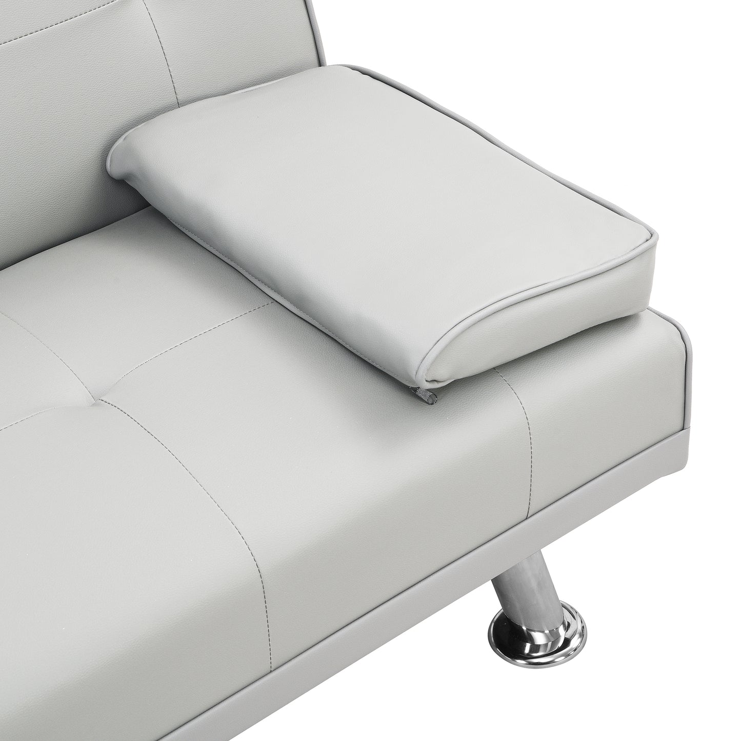 Closeup of a light grey faux leather sofa armrest with tufted stitching and a chrome leg