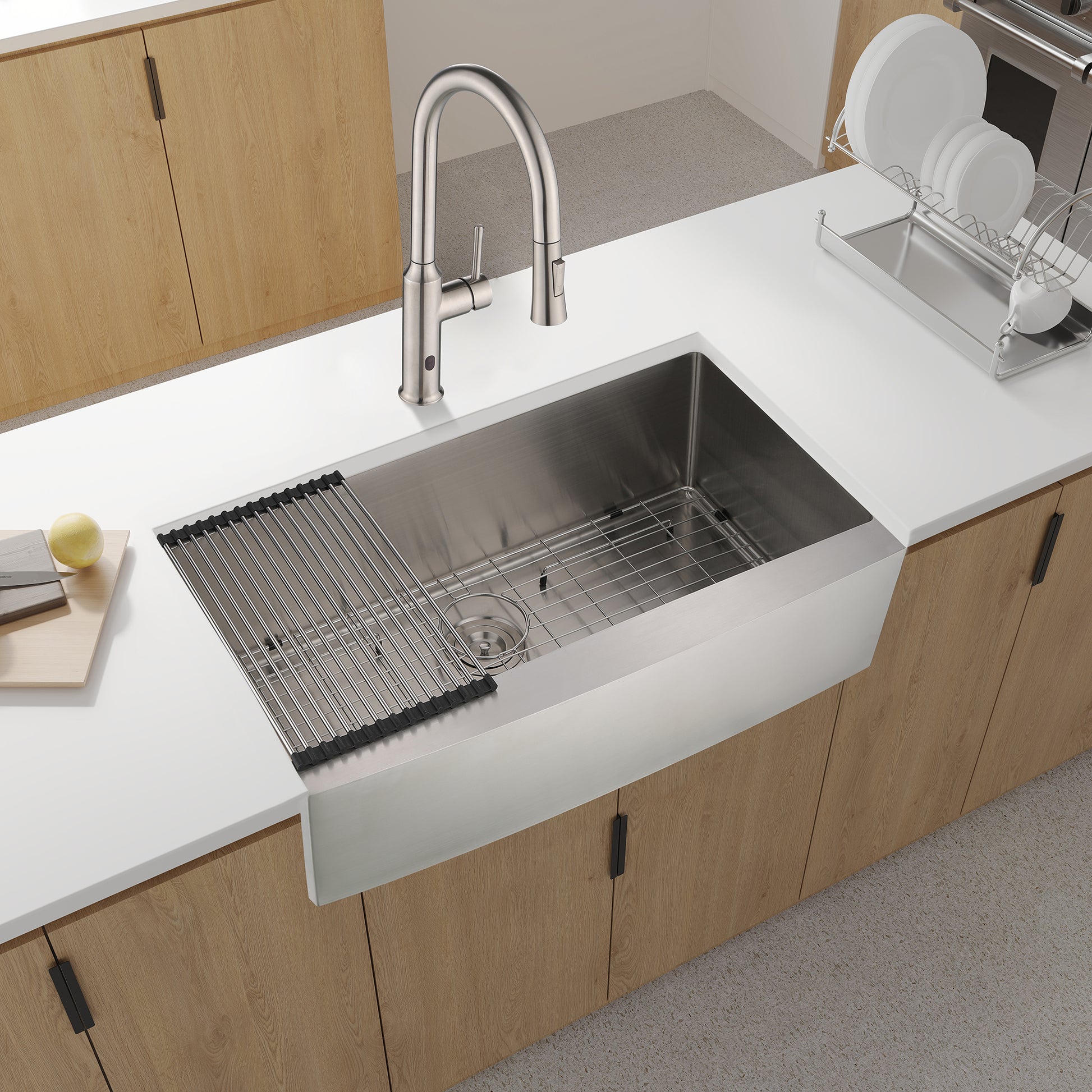 Brushed nickel farmhouse sink with integrated rollup drying rack for kitchen use
