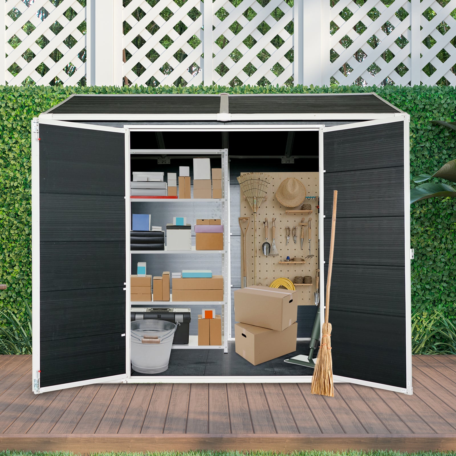Open black outdoor storage shed with shelves full of boxes and gardening tools