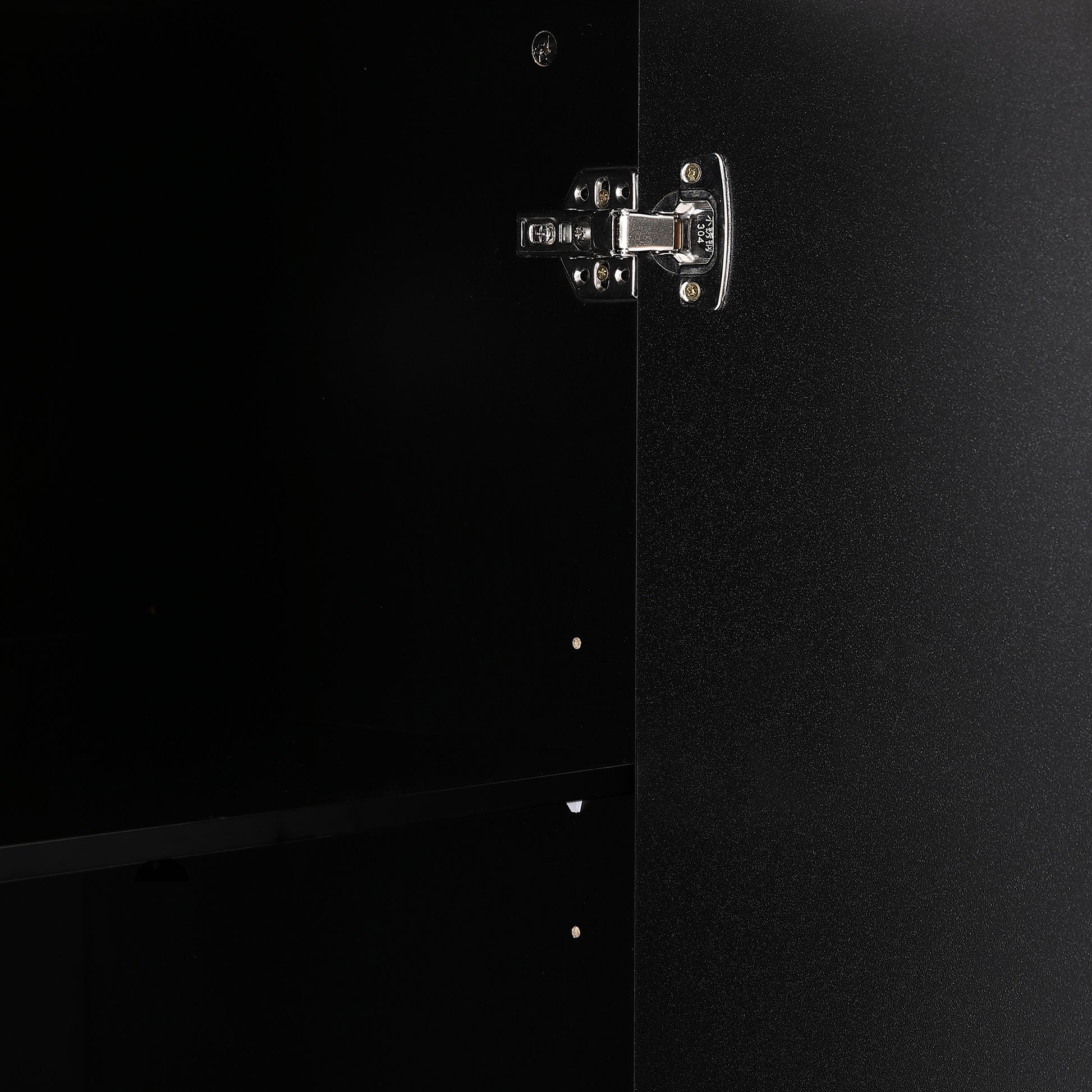 Closeup of a polished stainless steel cabinet hinge with  marking