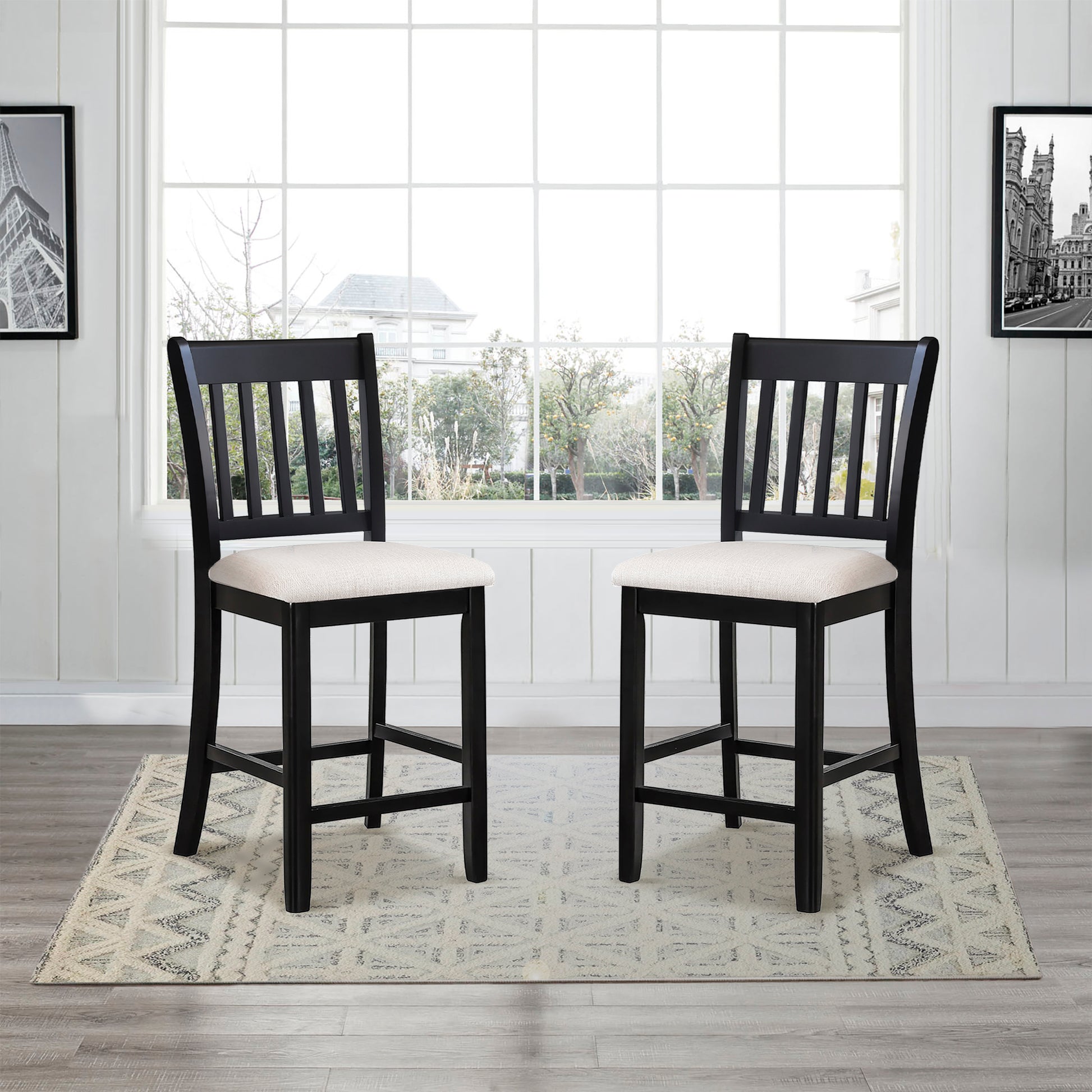 Two black wooden bar stools with cream fabric seats and slatted backs