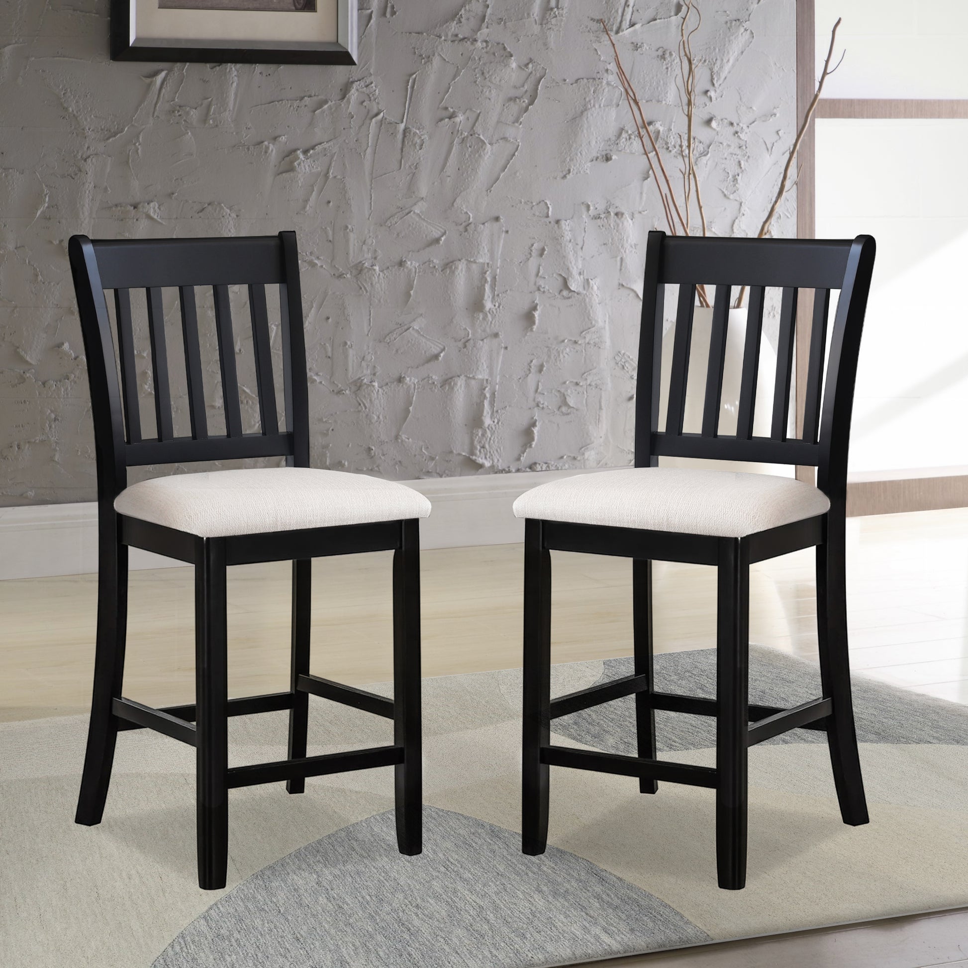 Two black wooden bar stools with white fabric seats perfect for kitchen islands