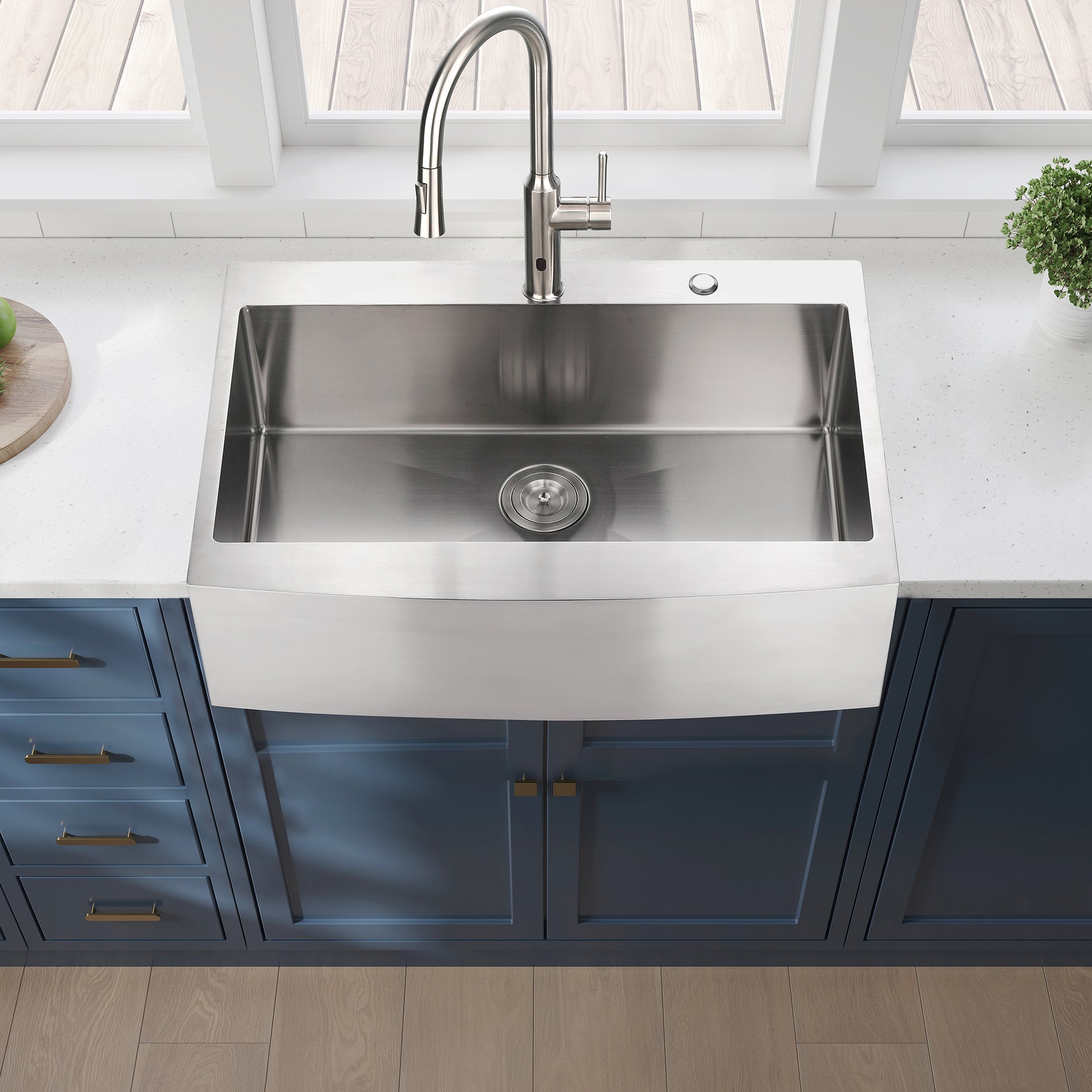 Stainless steel farmhouse sink with a brushed finish and curved apron front