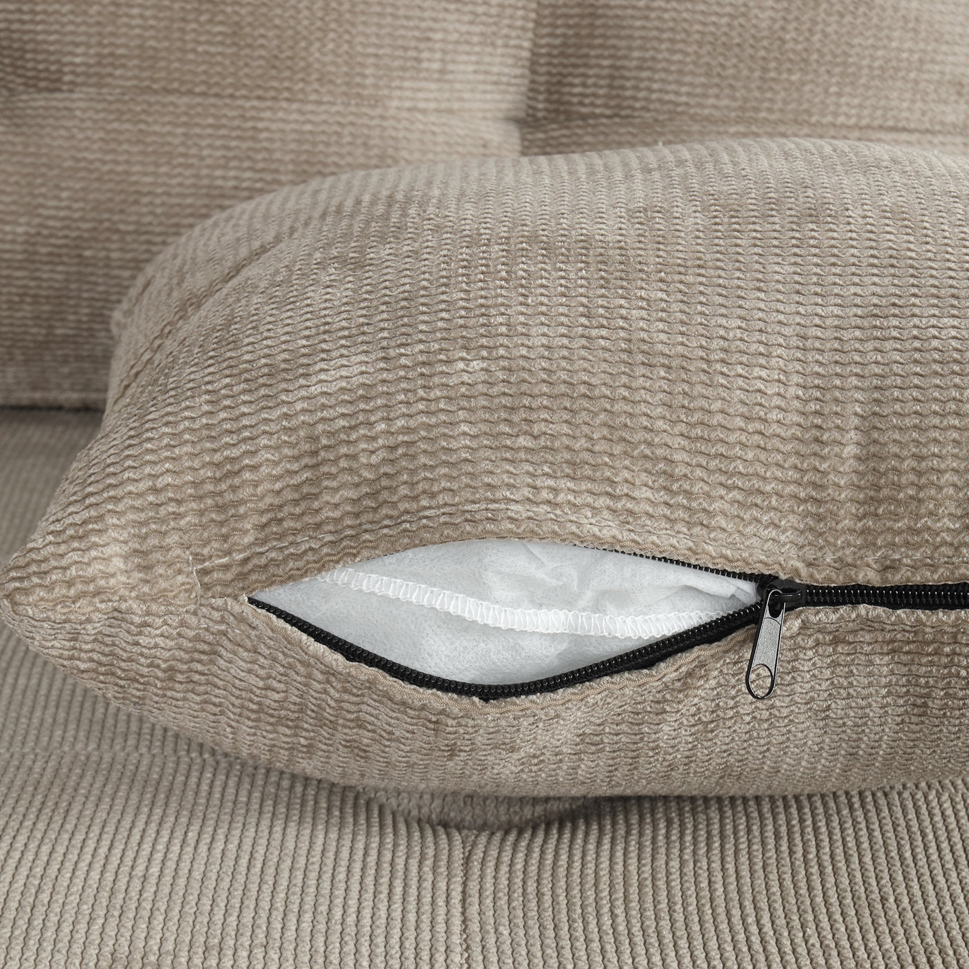 Textured beige cushion cover with visible zipper detail for easy removal