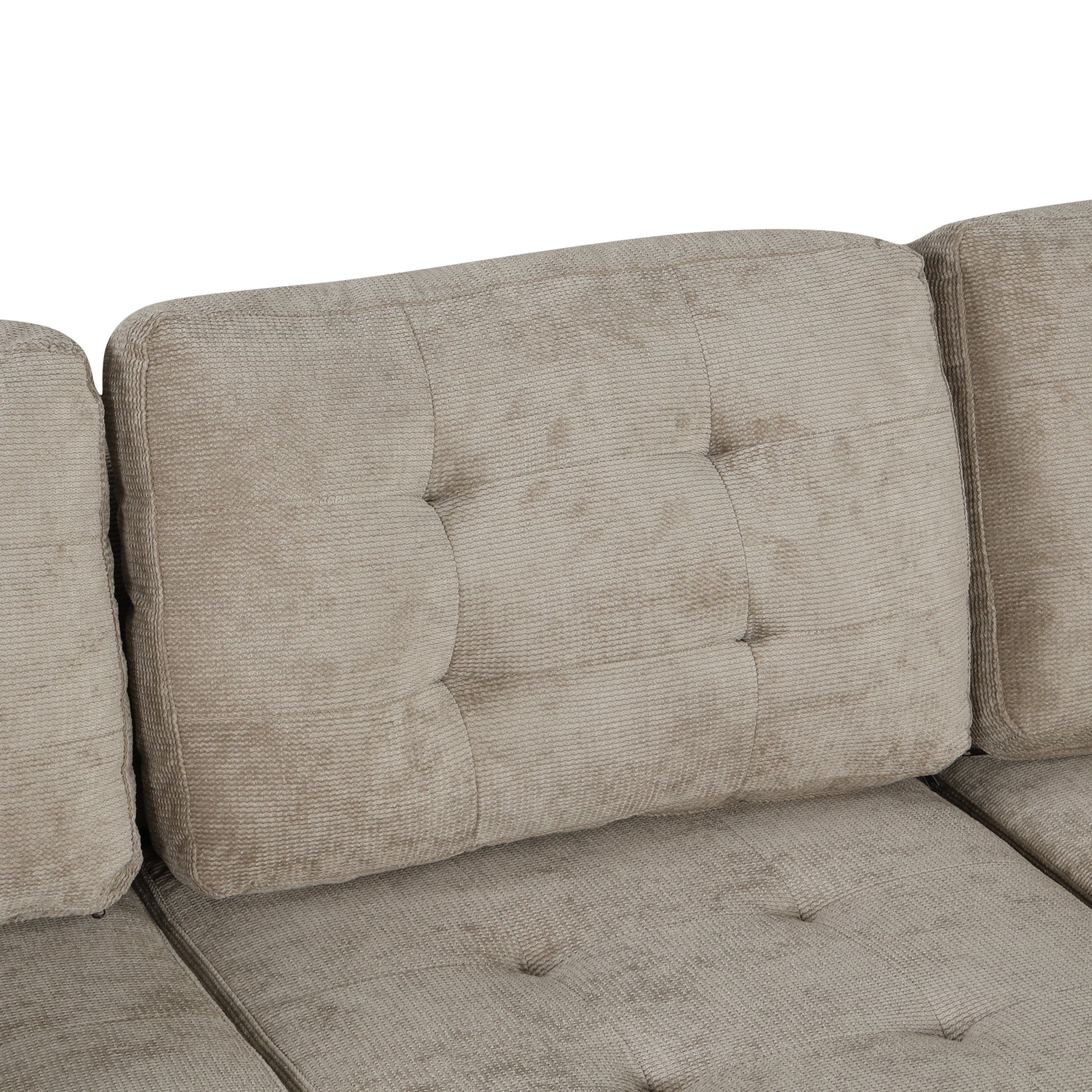 Tufted beige upholstered sofa back cushion with textured fabric detail
