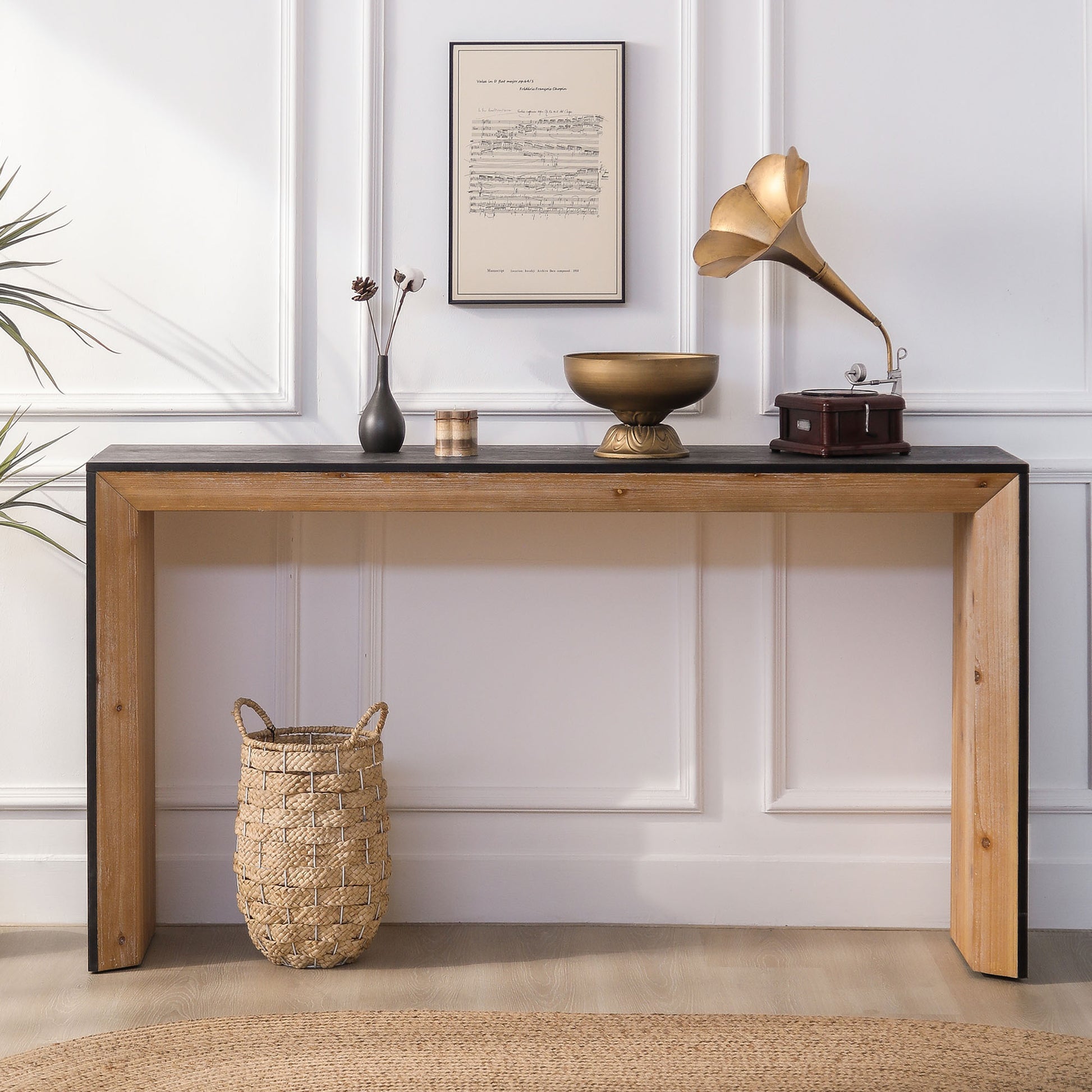 Rustic wood console table with black top featuring woven basket and antique gramophone