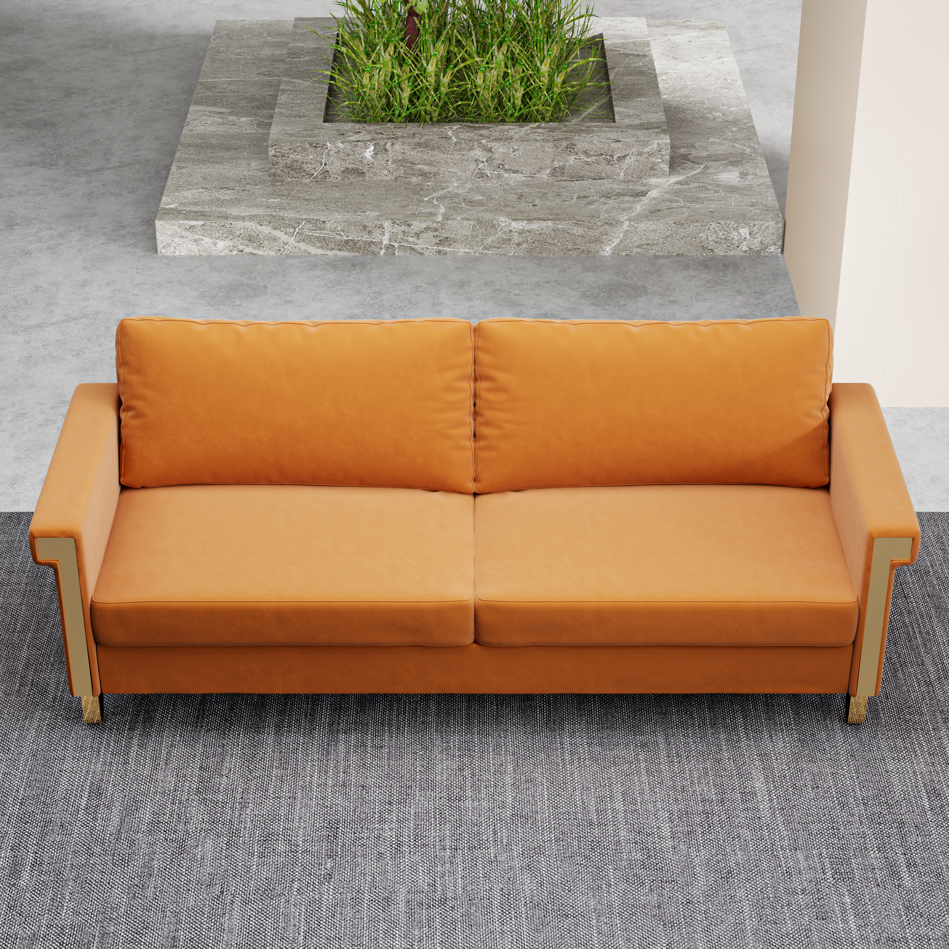 Burnt orange velvet sofa with golden accents on a grey textured rug