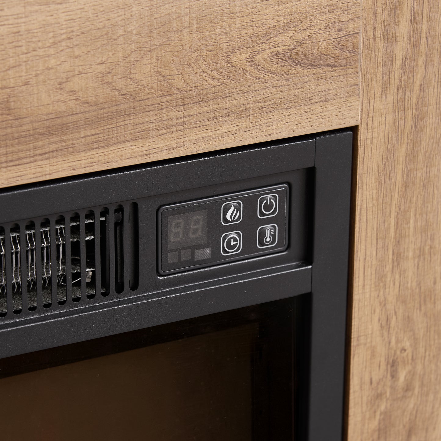 Closeup of an electric fireplace control panel with digital display flame and temperature icons