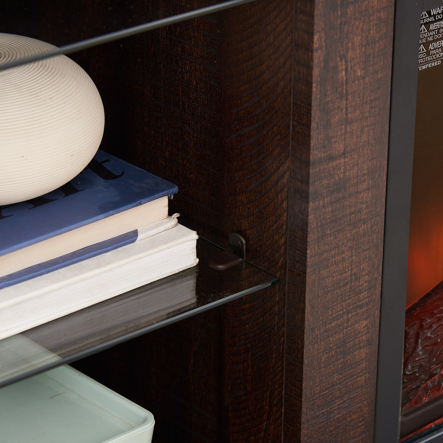 Closeup of a textured ceramic sphere decor on blue and white books