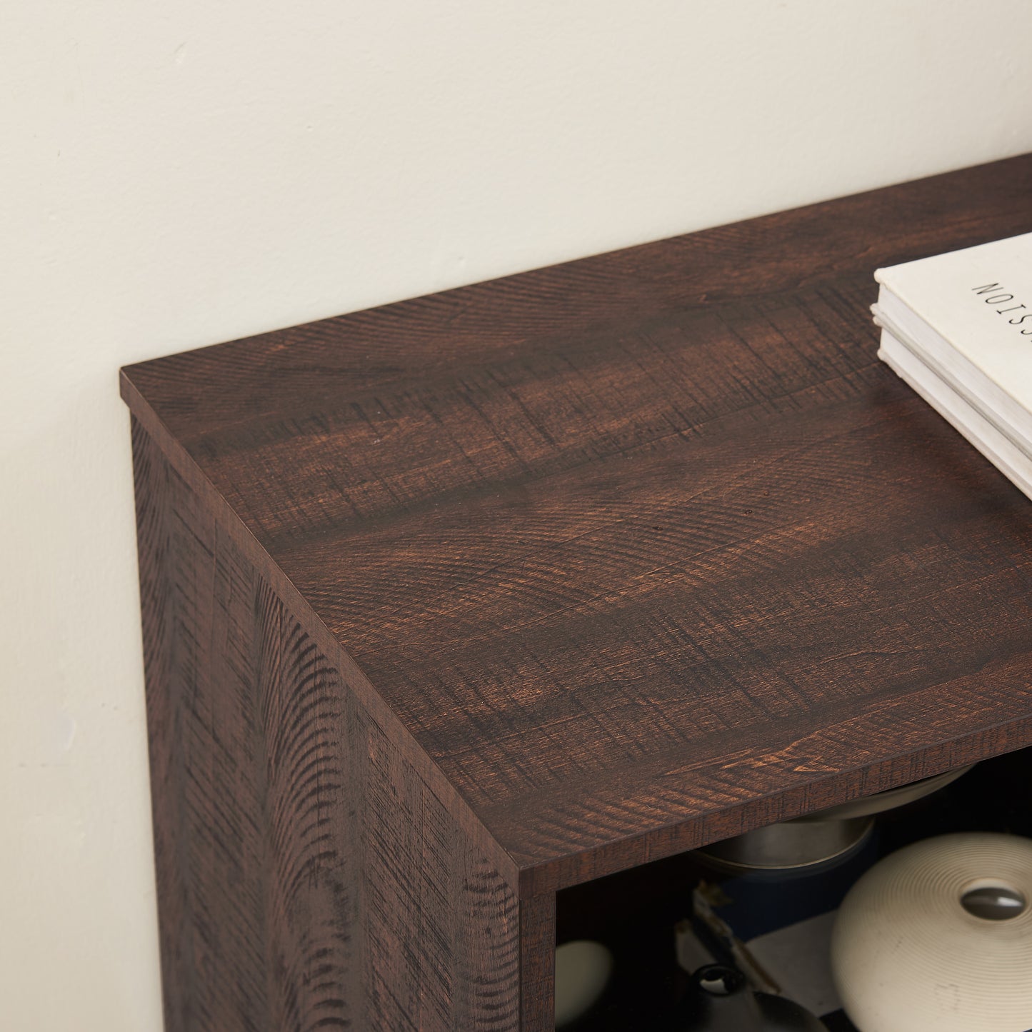 Dark brown distressed wood veneer bookshelf top with visible grain
