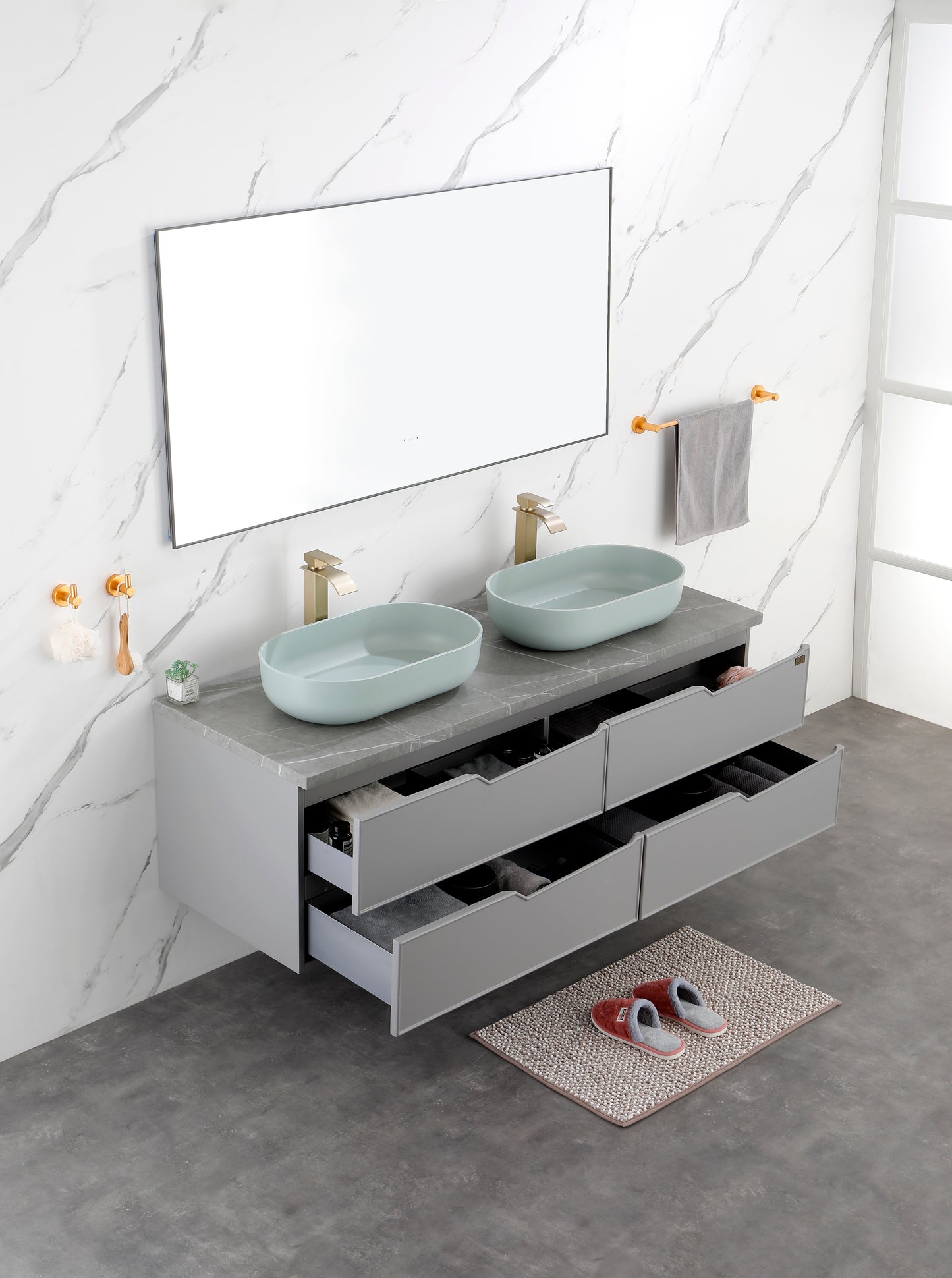 Grey wallmounted double vanity with light blue oval sinks and gold faucets