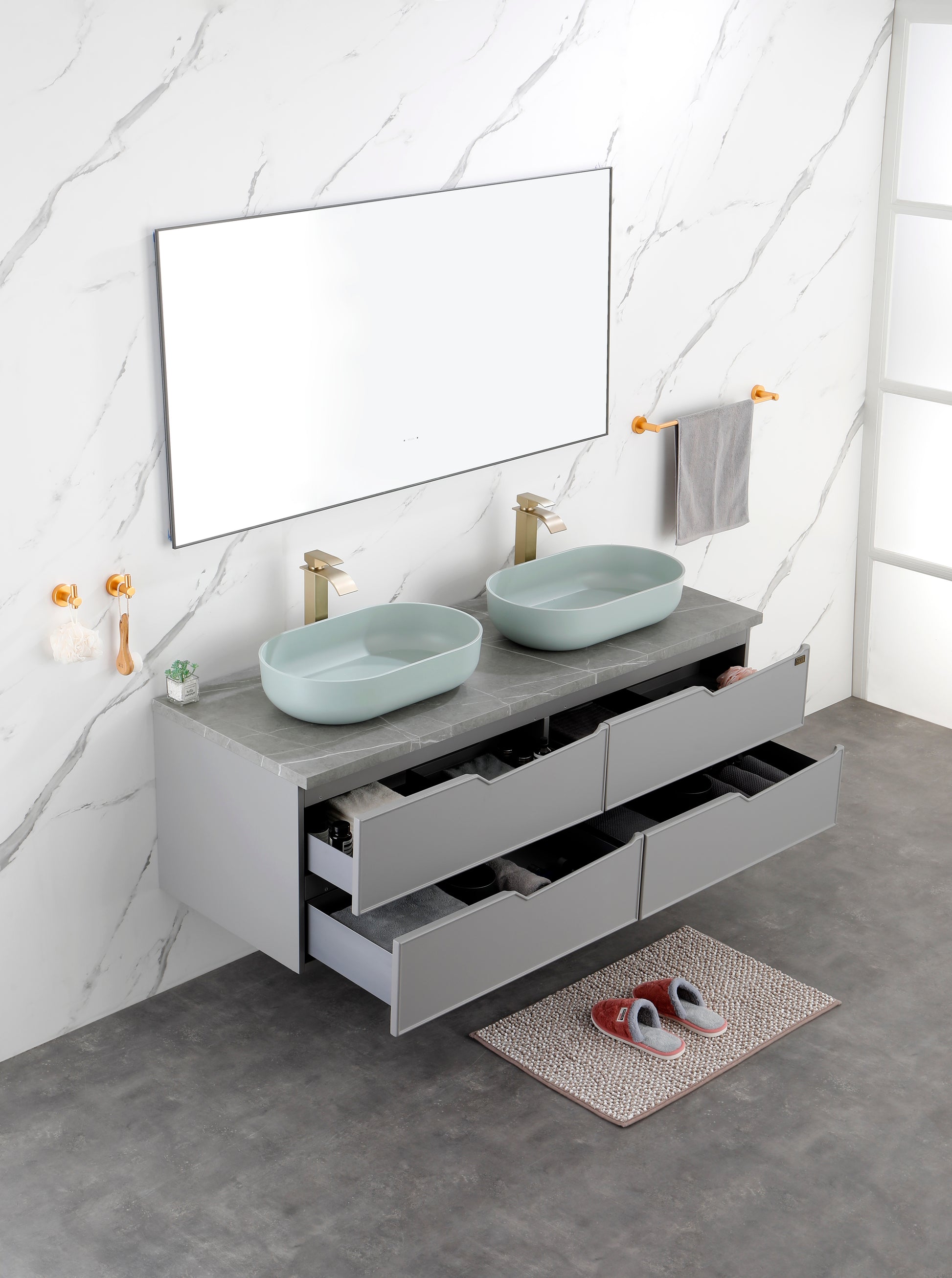 Grey wallmounted double vanity with light blue oval sinks and gold faucets