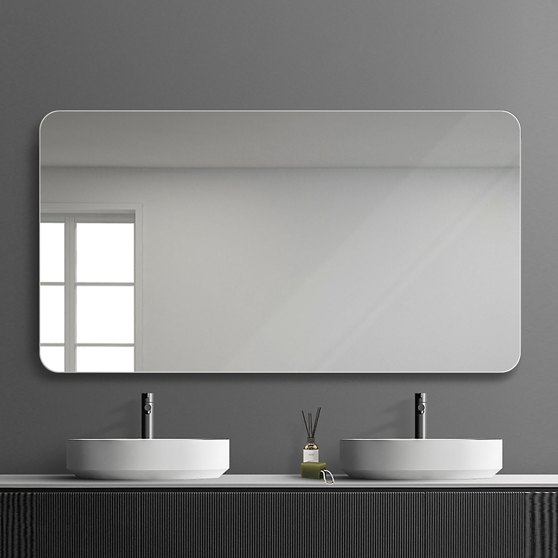 Large rounded rectangular bathroom mirror with sleek white frame mounted above double sinks