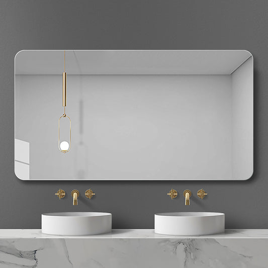 Modern rounded rectangle bathroom mirror with gold accents and minimalist vanity
