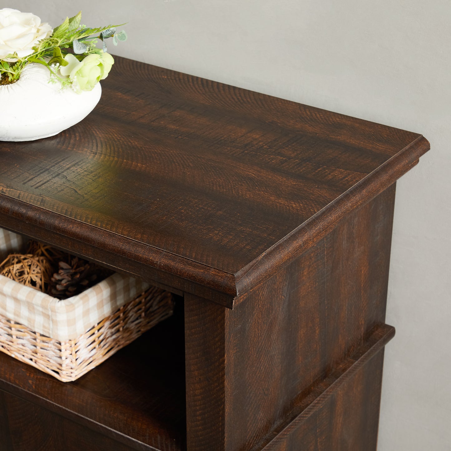 Dark oak wood dresser top with decorative basket and floral arrangement