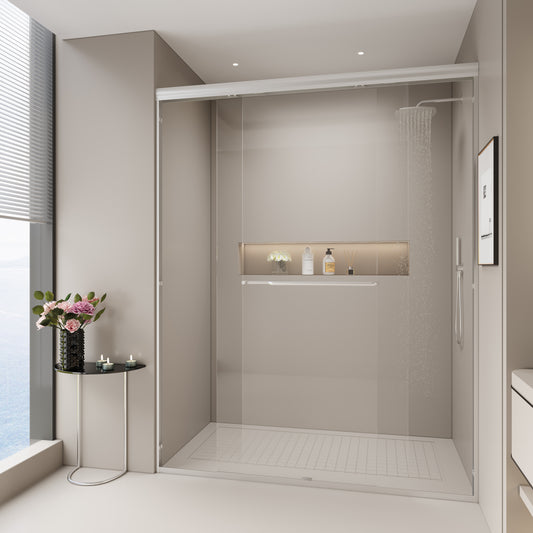 Modern glass shower enclosure with chrome fixtures and tiled base