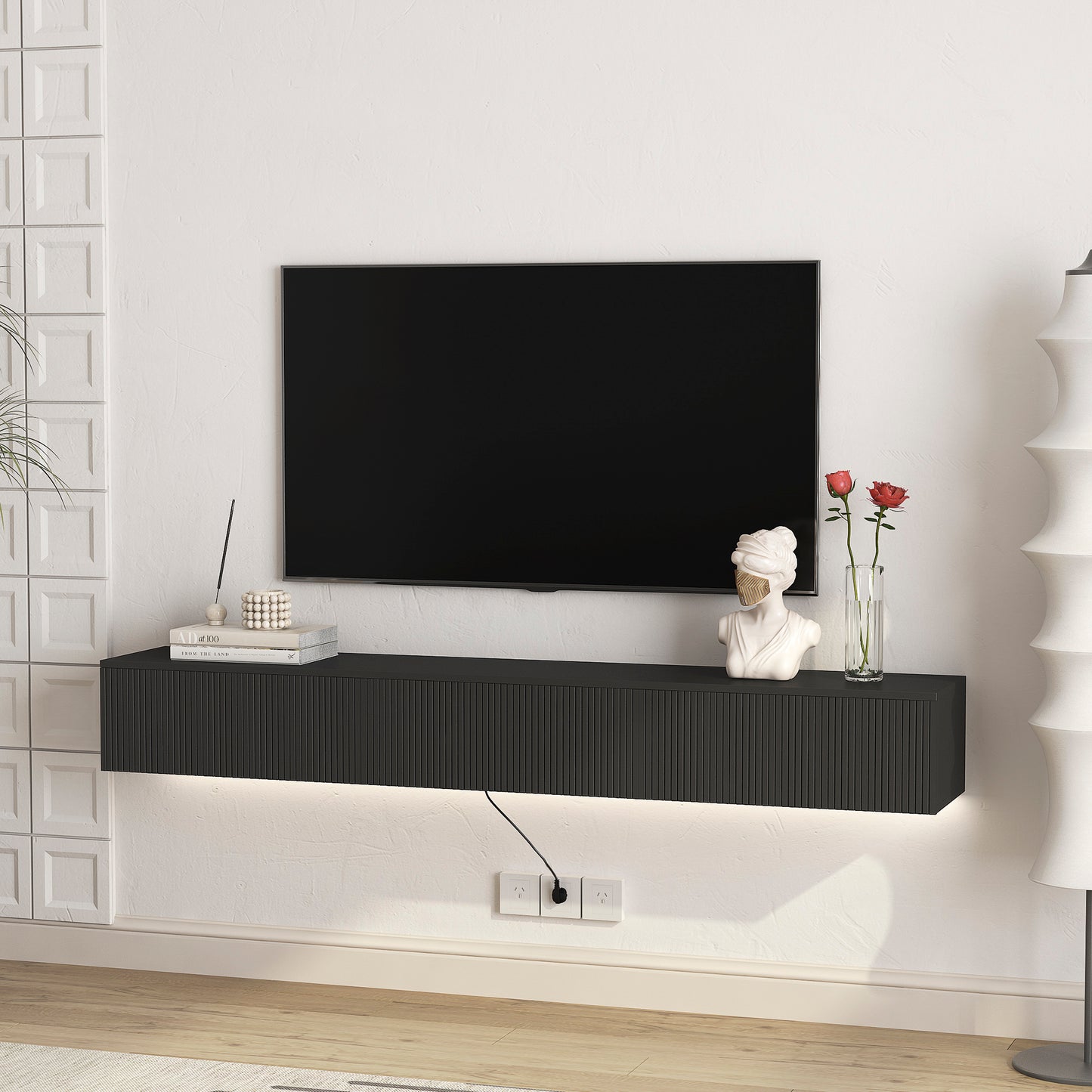 Modern floating black TV stand with ribbed drawer fronts and integrated LED lighting