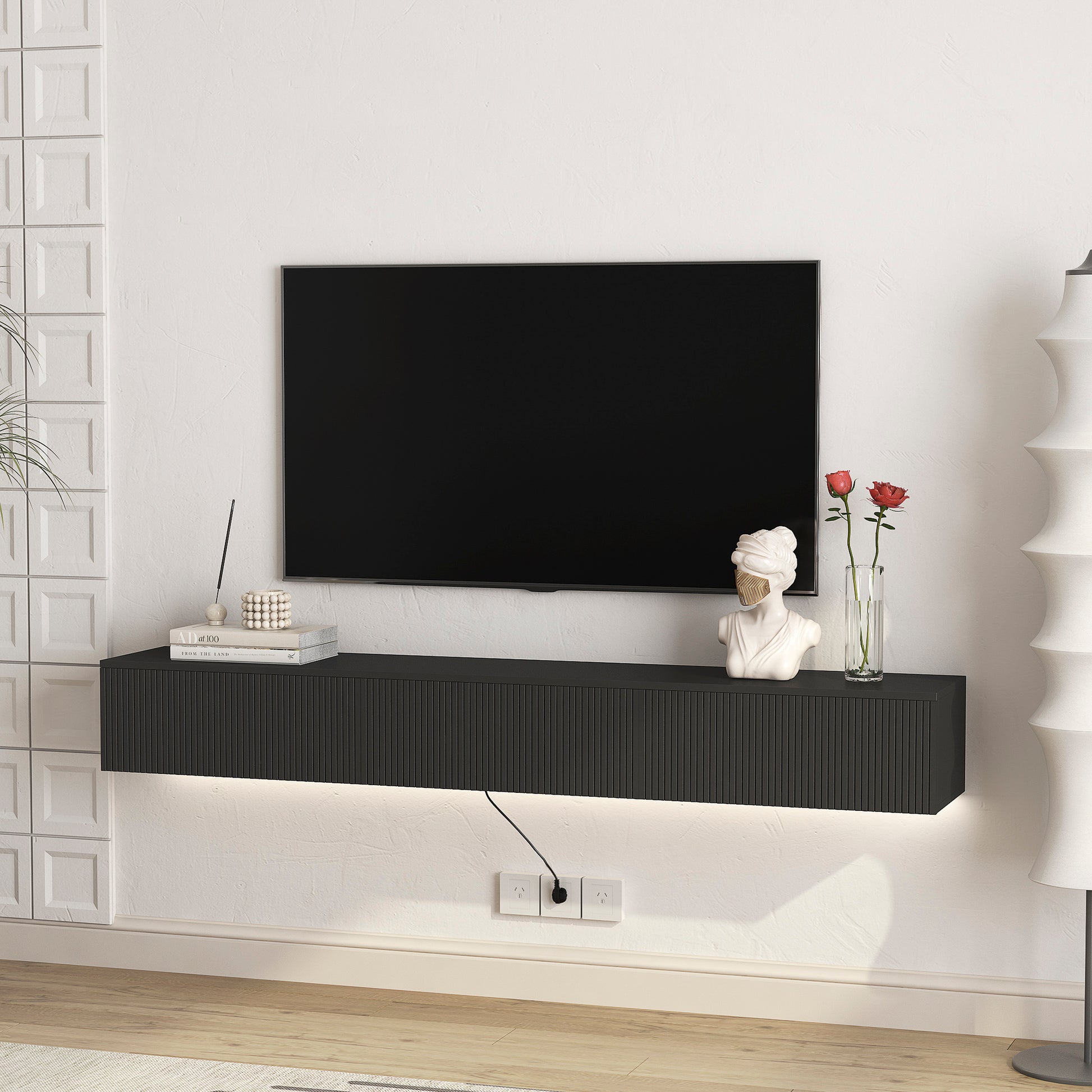 Modern floating black TV stand with ribbed drawer fronts and integrated LED lighting