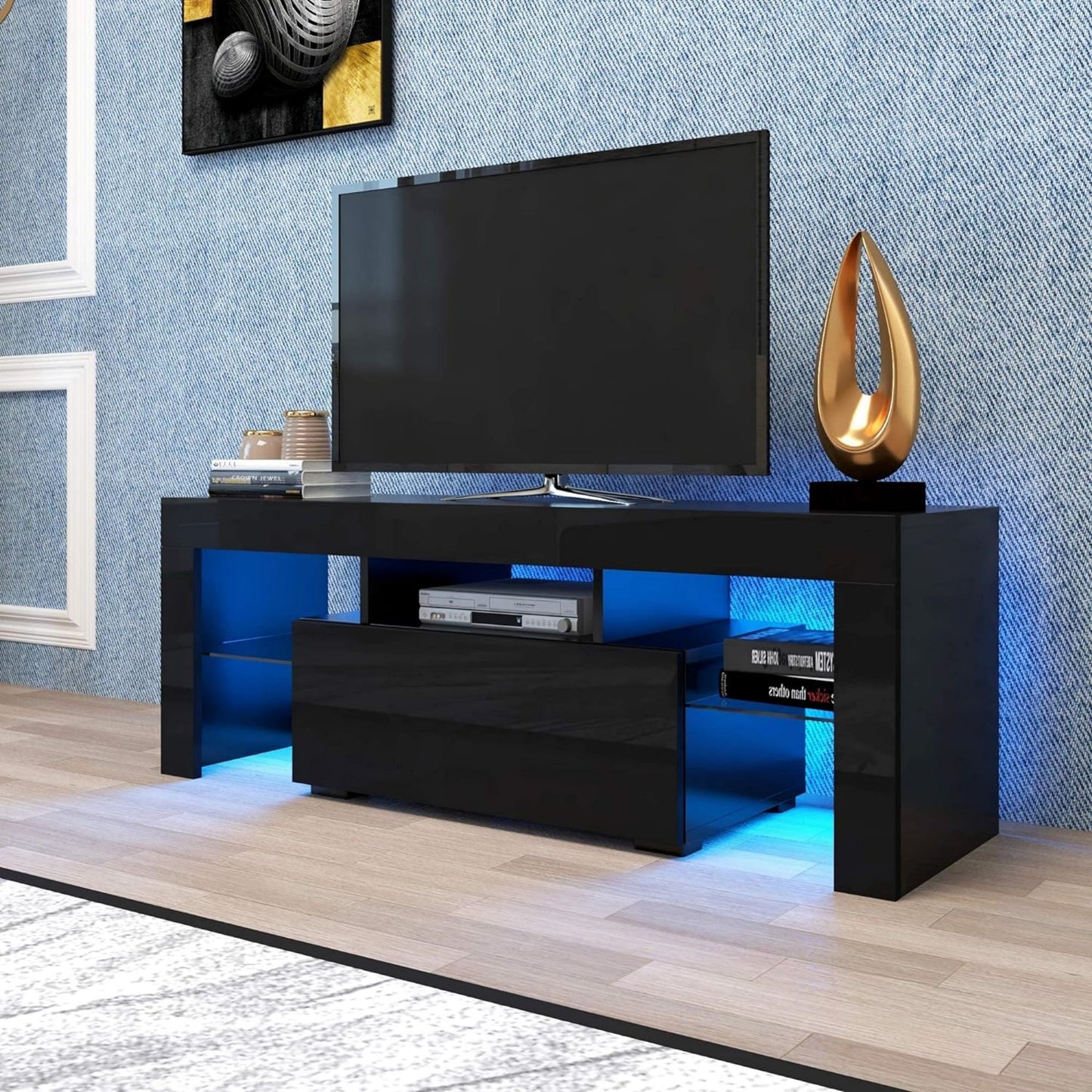 Glossy black TV stand with blue LED lighting featuring open shelves and a drawer for media consoles