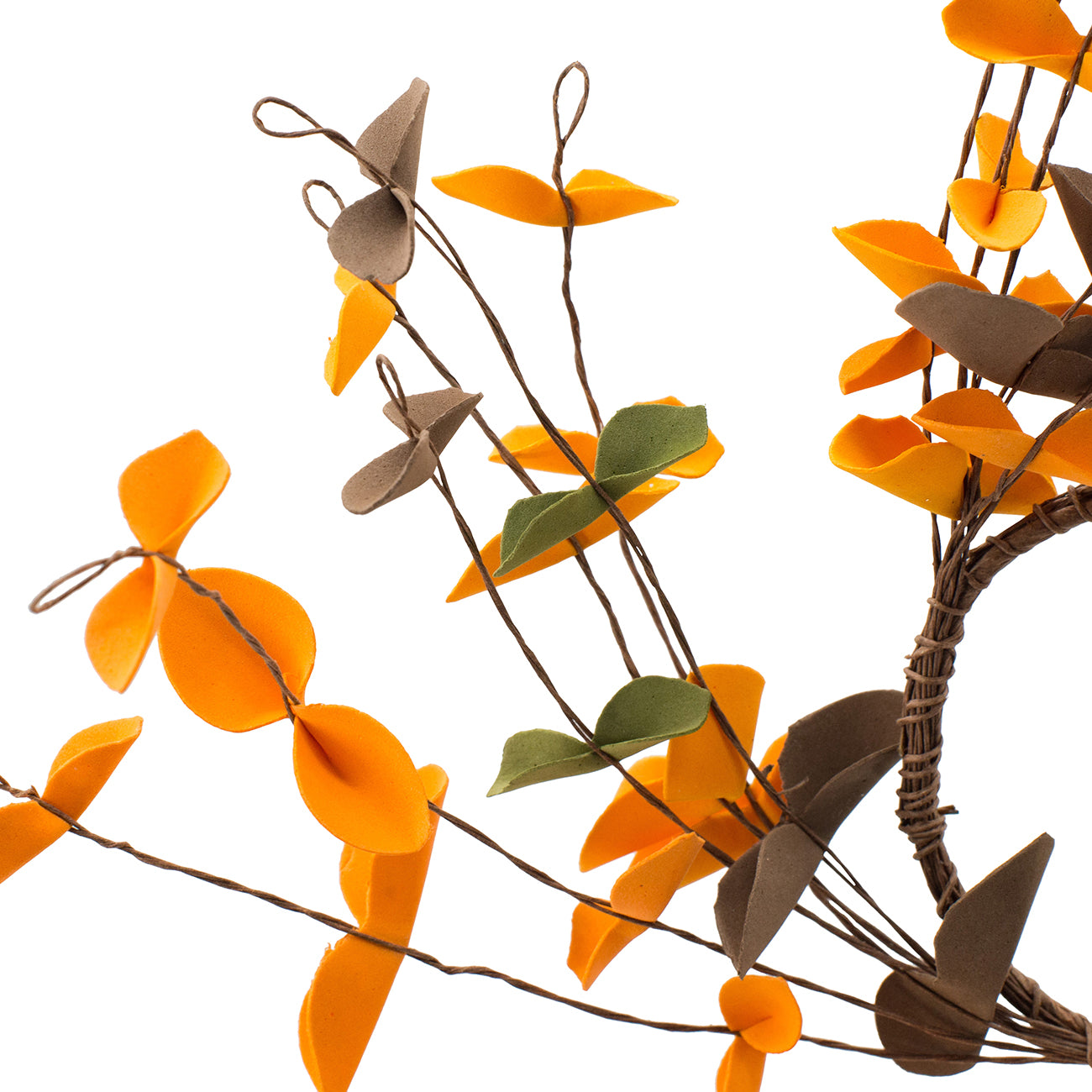 Artificial autumn leaves in orange brown and green on thin brown stems for fall decor